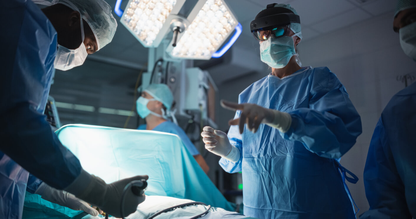Surgeons preparing tools in theatre environment